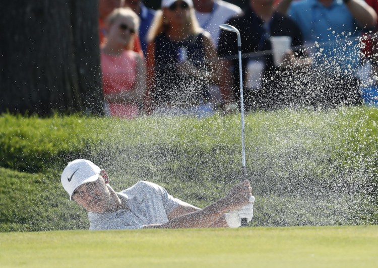 Associated Press/Jeff Roberson
Brooks Koepka hits out of a bunker onto the 14th hole during the third round of the PGA Championship on Saturday at Bellerive Country Club in St. Louis.
