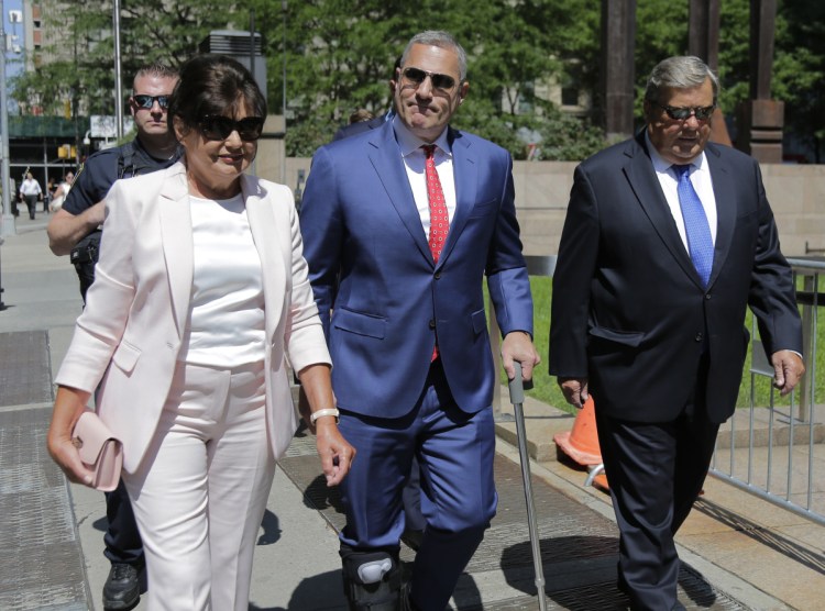First lady Melania Trump's Slovenian parents, Viktor, right, and Amalija Knavs, arrive Thursday to take the oath of citizenship with their attorney, Michael Wildes, in New York. They had been living in the U.S. as permanent residents.