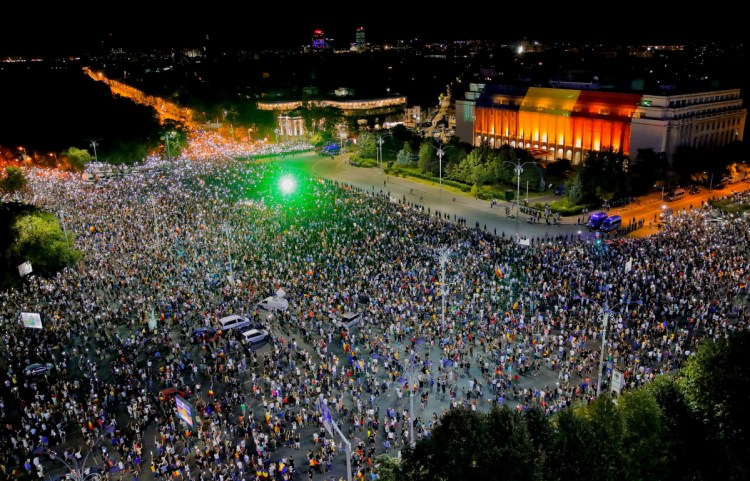 People shine lasers and the lights of their mobile phones during a protest outside the government headquarters in Bucharest, Romania, on Saturday. Romanians gathered for a second day of protest, a day after an anti-government demonstration turned violent.
