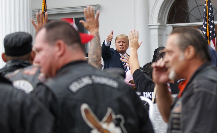 President Trump gives the thumbs-up Saturday to members of Bikers for Trump outside the clubhouse of Trump National Golf Club in Bedminster, N.J.