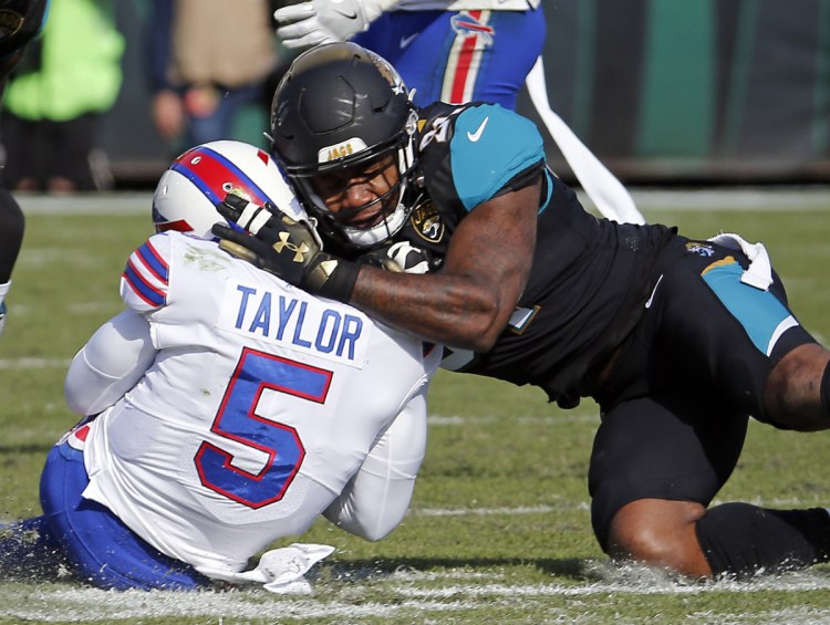 Jaguars defensive end Yannick Ngakoue, shown here tackling Bills quarterback Tyrod Taylor last season, had to be separated from teammate Dante Fowler multiple times after practice on Sunday.