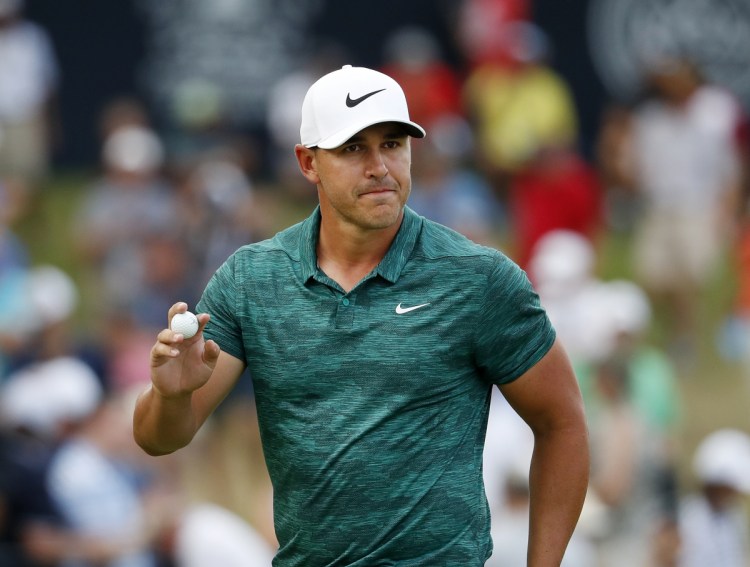 Brooks Koepka waves to the crowd after making his birdie putt on the 15th green during the final round of the PGA Championship on Sunday at Bellerive Country Club in St. Louis.