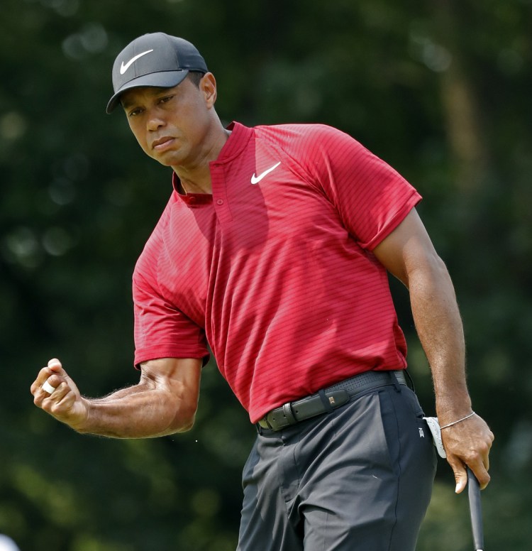 Tiger Woods celebrates after sinking a birdie putt on the ninth hole Sunday during the final round of the PGA Championship. Woods settled for second place despite closing with a 6-under 64.