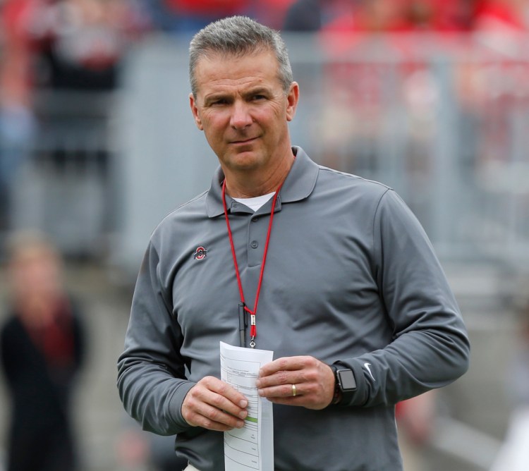 Ohio State Coach Urban Meyer is on paid administrative leave while the school investigates whether he responded properly to accusations of domestic abuse made against one of his coaches, who has been fired.