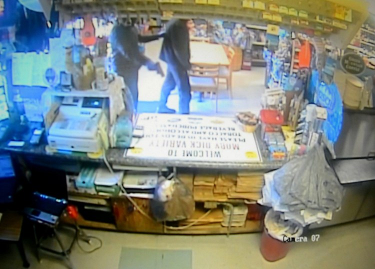 Surveillance video shows an armed robber holding up Moby Dick Variety Store in Old Orchard Beach in April. It was one of more than a dozen crimes being investigated by the FBI and local authorities.