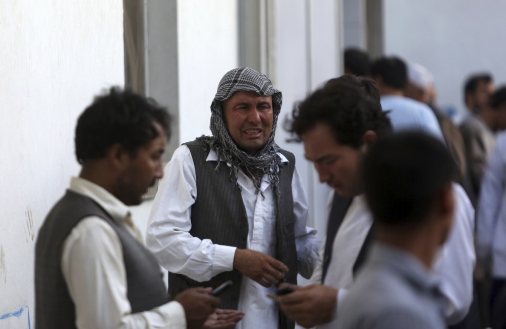 Afghans mourn a victim of a deadly suicide bombing that targeted a training class in a private building in the Shiite neighbourhood of Dasht-i Barcha, in western Kabul on Wednesday.