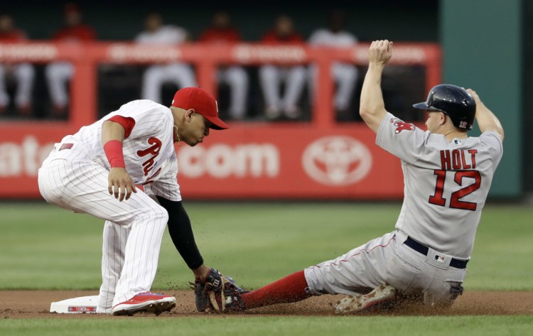 Phillies second baseman Cesar Hernandez tags out Boston's Brock Holt at second after Holt tried to steal during the first inning Wednesday night in Philadelphia.