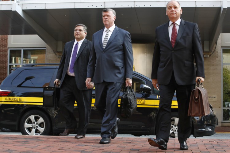 Defense attorneys Richard Westling, left, Kevin Downing, and Thomas Zehnle walk to federal court as jury deliberations begin in the trial of former Trump campaign chairman Paul Manafort, in Alexandria, Va., on Thursday.