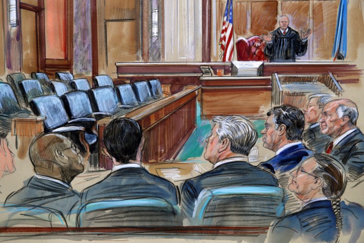 This courtroom sketch depicts U.S. District Court Judge T.S. Ellis III speaking to the lawyers and defendant Paul Manafort, fourth from left, as the jury continues to deliberate in Manafort's trial on bank fraud and tax evasion at federal court in Alexandria, Va., on Friday. Third from left is Manafort's attorney Kevin Downing.