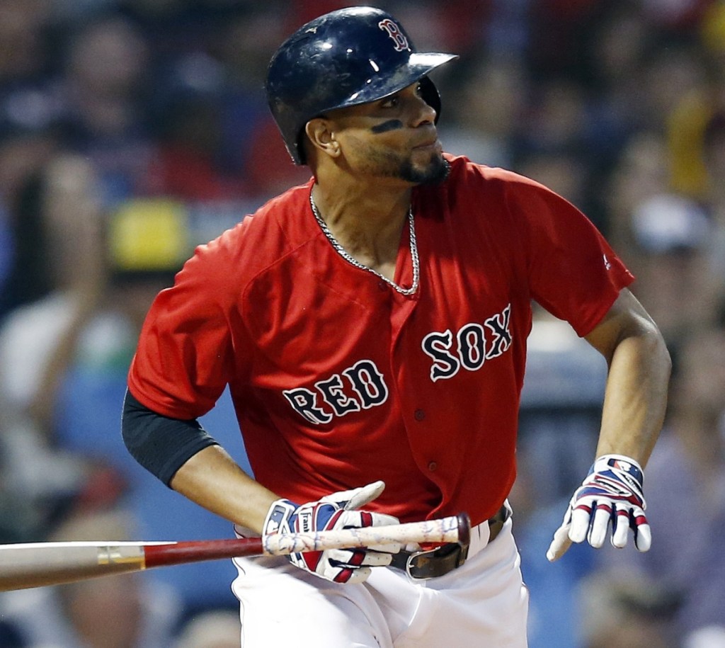 Xander Bogaerts of the Boston Red Sox watches his two-run triple Friday night during the first inning of the 7-3 victory against the Tampa Bay Rays at Fenway Park.