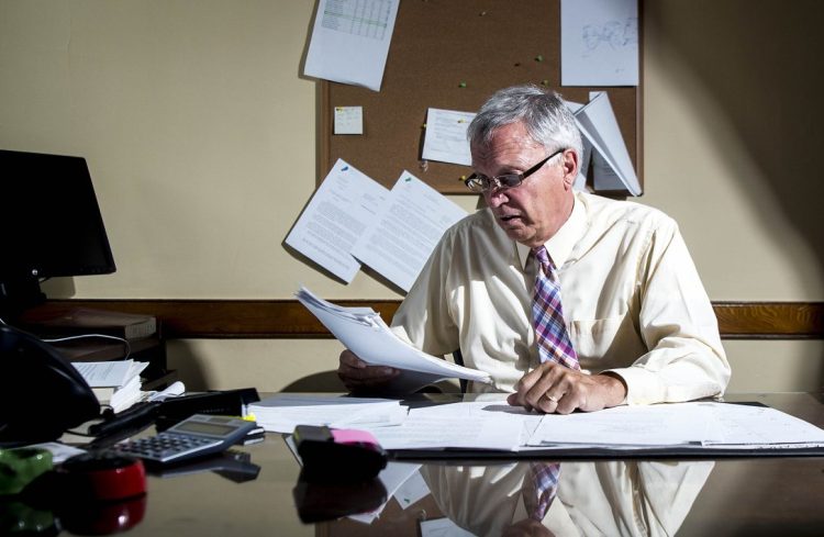 Justice Robert Mullen reviews juror paperwork in his chambers at the Somerset Superior Court on Friday.