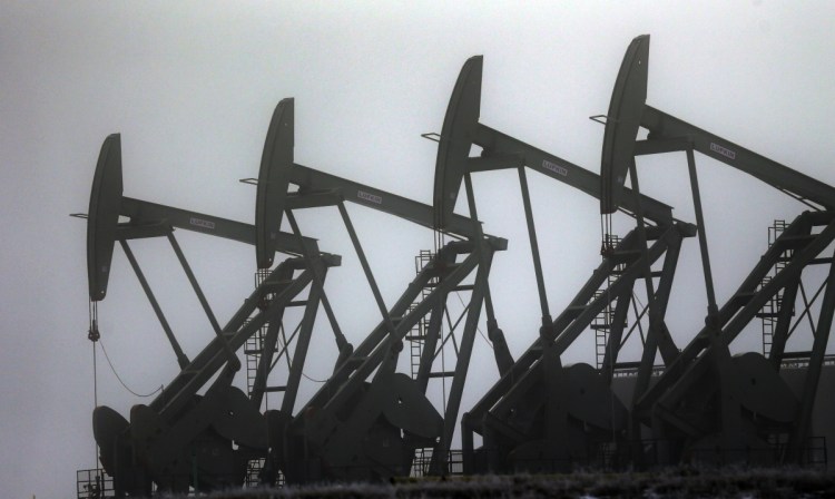 Oil pump jacks work in Williston, N.D. Conserving oil is no longer an economic imperative, the Energy Department says.