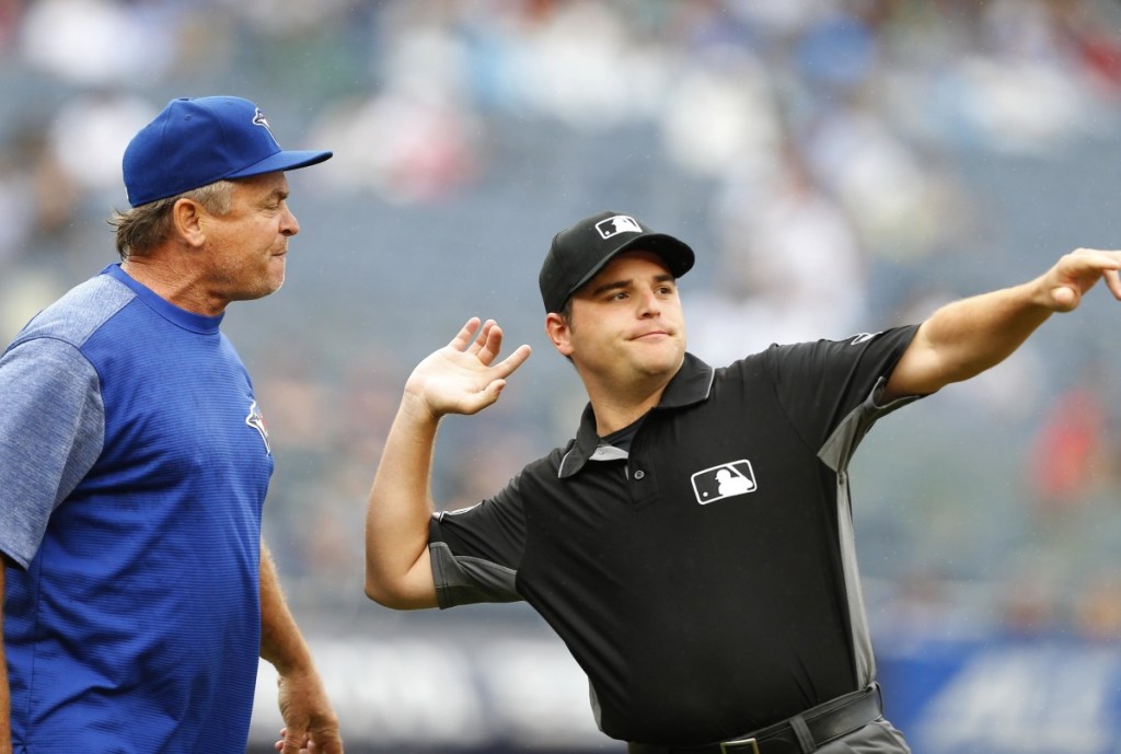 First base umpire Jansen Visconti ejects Blue Jays Manager John Gibbons in the sixth inning of Sunday's game in New York. The Yankees beat Toronto 10-2 to complete a three-game sweep.