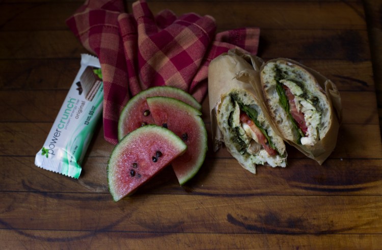 A substantial sandwich, protein bar and fruit comprise a lunch that can carry a hungry teen through a busy 12-hour day of classes, activities and sports.