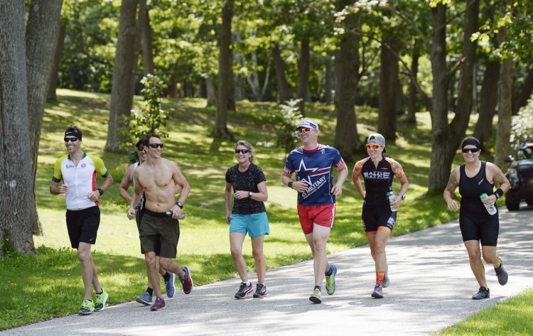 Runners finish the Stone Coast Challenge at Ft. Williams Park in Cape Elizabeth Thursday. Runners are, from left, Charlie Peters, Navy; Chris Kelley, Navy; Chad Kalocinski, Navy; Jen Fullmer, Air Force; Eric Libner, Coast Guard; Meghan Skidmore and Cam Kovarek, Navy.