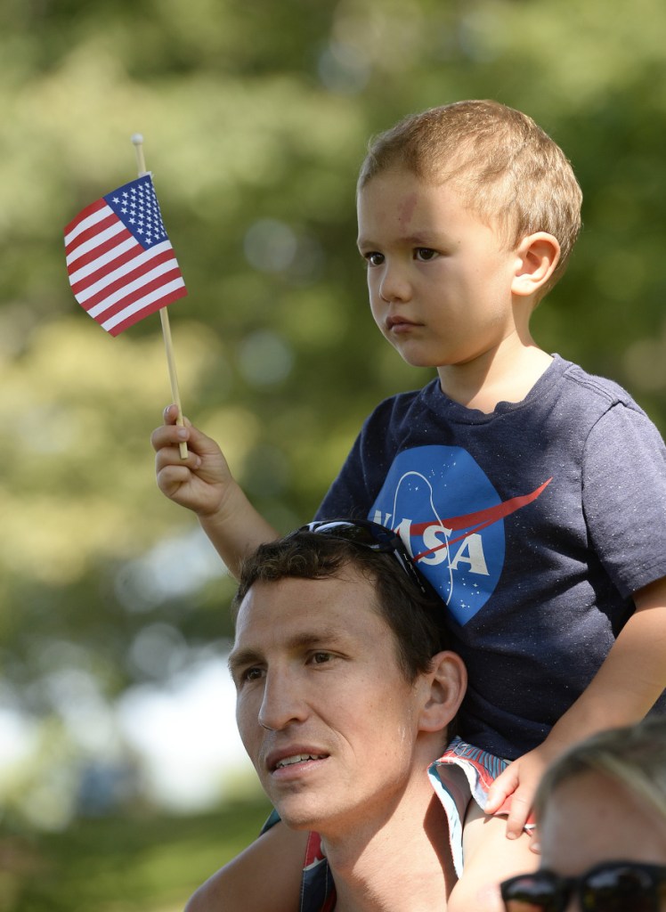 Chad Kalocinski, Navy, with his son Patrick, 4, on his shoulders after completing the Stone Coast Challenge on Thursday.
