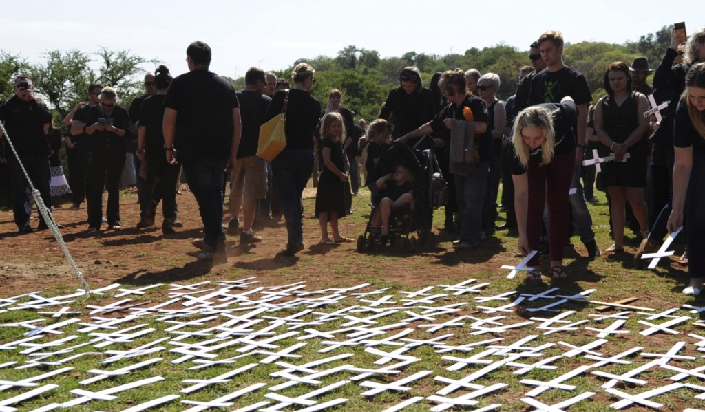 People place white crosses, representing farmers killed in the country, at a ceremony at the Vorrtrekker Monument in Pretoria, South Africa, in 2017.