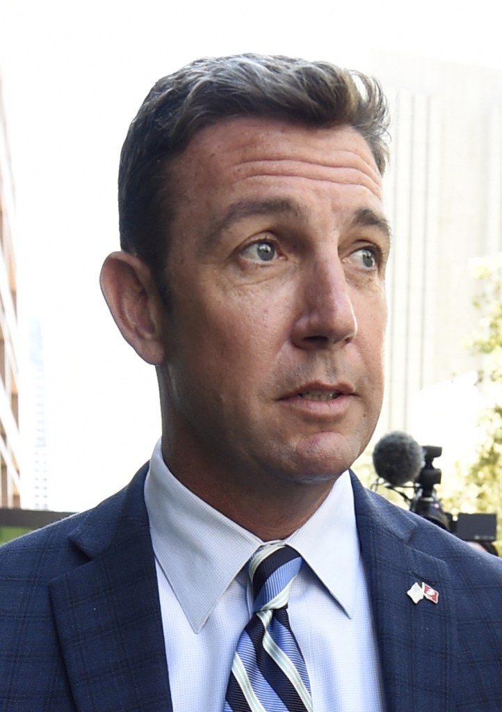 Protesters chant slogans as U.S. Rep. Duncan Hunter arrives for an arraignment hearing Thursday in San Diego. Hunter and his wife were indicted Tuesday.
