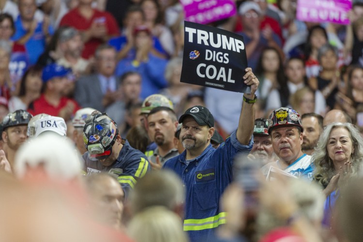 Coal miners wait for President Trump to take the stage at a rally in Charleston last week. The administration's plan to ease carbon dioxide limits would also allow efficiency upgrades to old plants without requiring emissions controls.