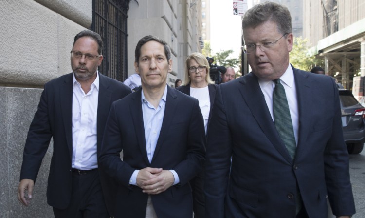 Former CDC director Thomas Frieden, center, leaves Brooklyn federal court Friday in New York.