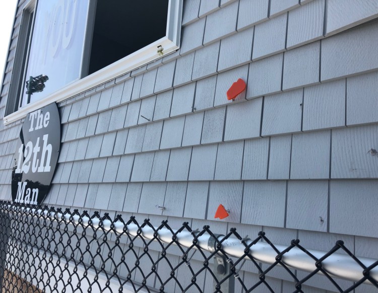 Bits of the "Tiger Pride" sign and nails mark the place where it hung before it was stolen from Waterhouse Field in Biddeford late Thursday.