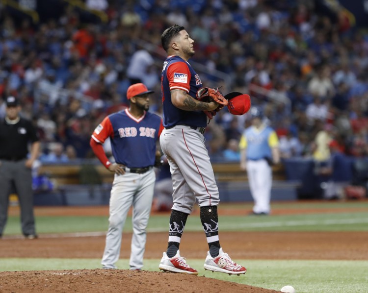 Red Sox starter Hector Velazquez stands on the mound after giving up a run during the third inning Friday night in St. Petersburg, Fla. The Rays scored 10 runs in the first four innings to win their sixth straight, 10-3.
