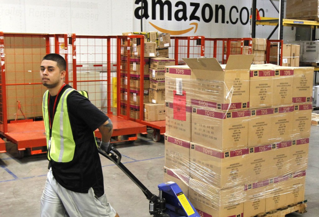 Humberto Manzano Jr. delivers an arriving pallet of goods at an Amazon.com fulfillment center in Phoenix. Amazon employs more than 575,000 workers nationwide.