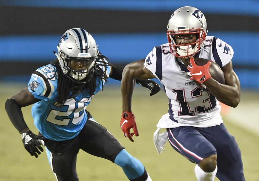 Patriots receiver Phillip Dorsett, right, runs past Carolina Panthers defender Donte Jackson during the first half of Friday's preseason game in Charlotte, N.C. Dorsett had four catches for 36 yards as he continues to earn Tom Brady's trust.