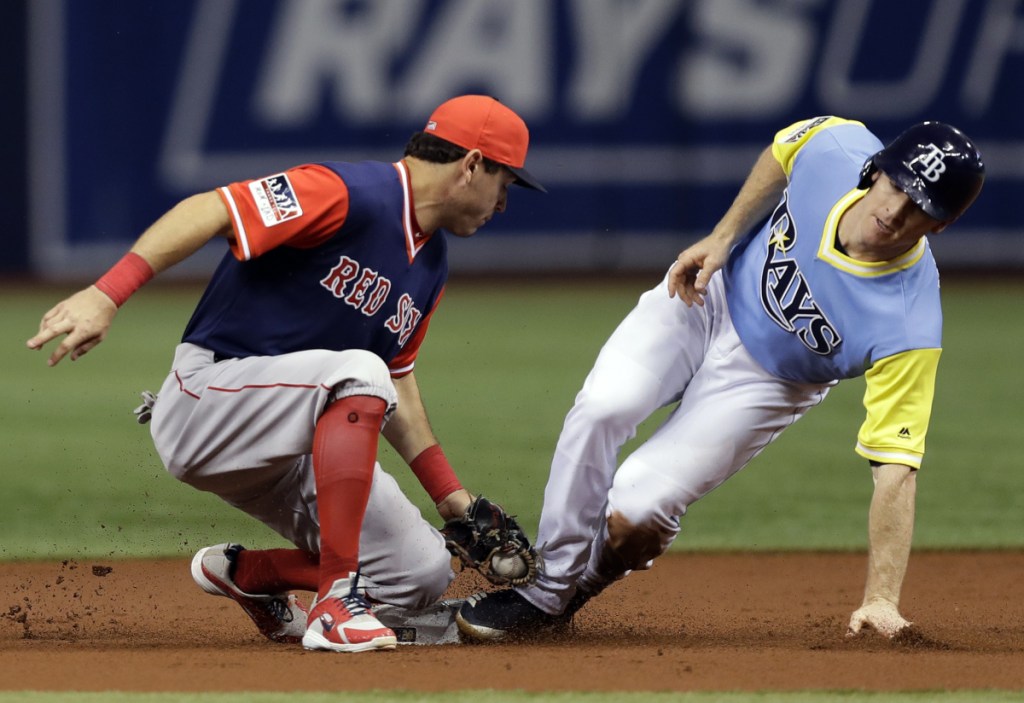 Red Sox second baseman Ian Kinsler is late with the tag as Tampa Bay's Joey Wendle steals second base Saturday night in St. Petersburg, Fla. Boston lost for the second straight night, 5-1.