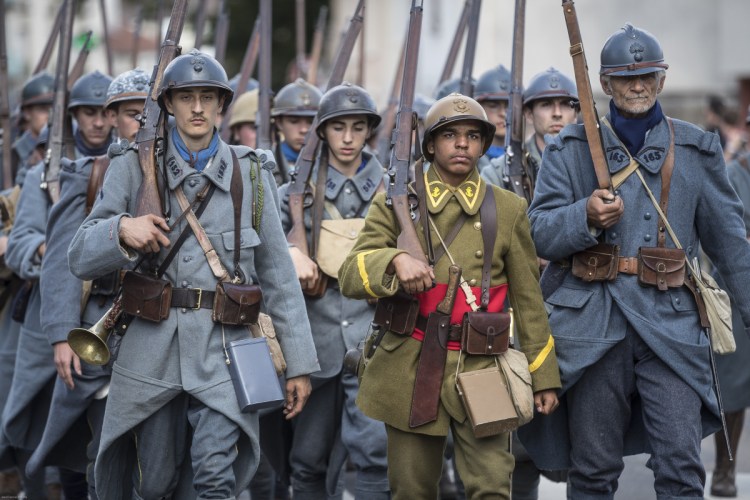 Volunteers dressed in World War I uniforms march during a parade, part of a reconstruction of the battle of Verdun, on Saturday in Verdun, eastern France.