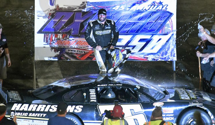 Bubba Pollard emerges from his car after winning the Oxford 25 on Sunday at Oxford Plains Speedway.