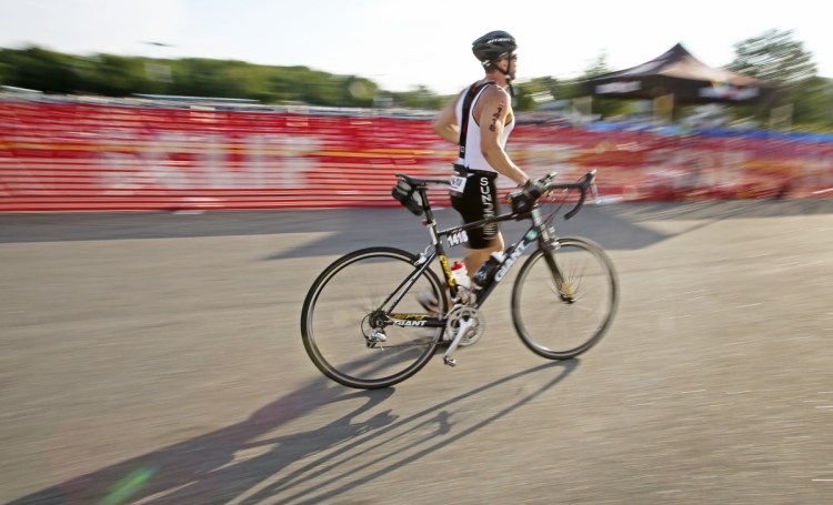 A cyclist makes his way from the first transition area en route to the 56-mile biking portion of the Ironman 70.3 Maine triathlon in Old Orchard Beach on Sunday. About 2,000 athletes competed in the triathlon. 