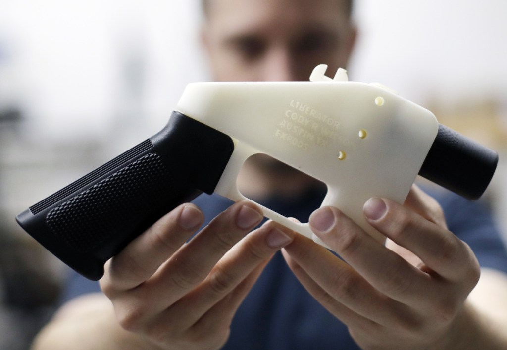 Cody Wilson, with Defense Distributed, holds a 3D-printed gun. A federal judge  has barred the company from posting plans online.