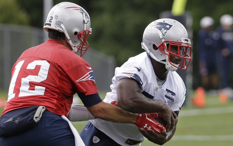 New England rookie running back Sony Michel, right, is back on the practice field after suffering a knee injury on Aug. 1 – but he hasn't been cleared yet by doctors to go full tilt.