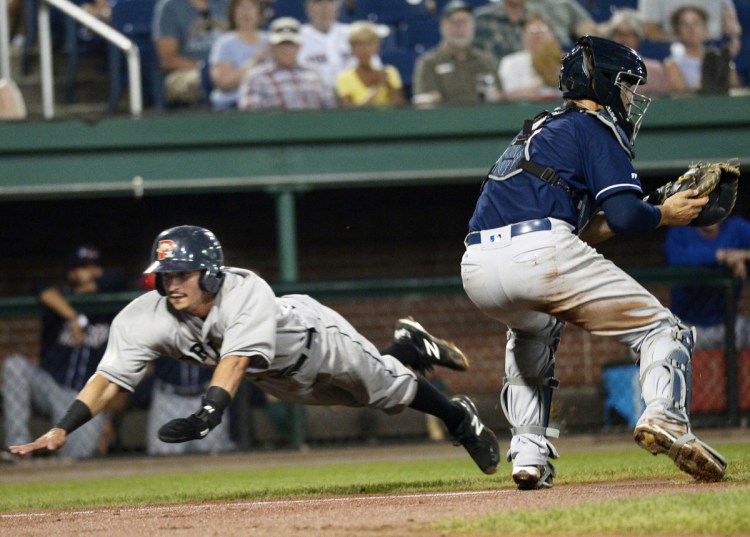 Jeremy Rivera dives past New Hampshire's catcher Max Pentecost to score a run in the first inning. Rivera went 3 for 5 with three runs scored, and the first three batters in the Sea Dogs lineup collected eight hits, five runs and five RBI.