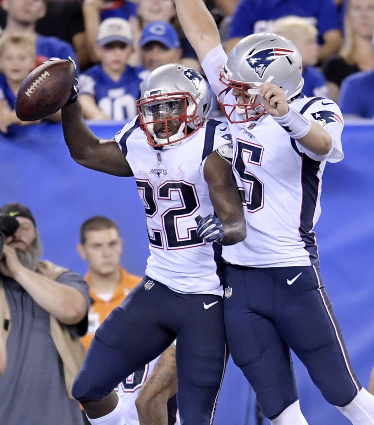 New England quarterback Danny Etling, right, and running back Ralph Webb celebrate after connecting on a touchdown pass during Thursday night's preseason finale.