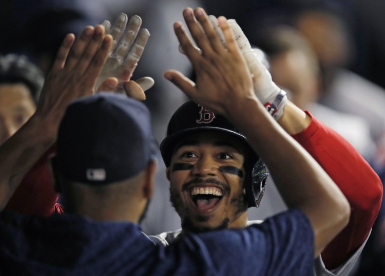 Mookie Betts celebrates after hitting a two-run home run against the Chicago White Sox in the seventh inning Thursday night in Chicago.