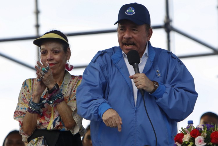 Nicaragua's President Daniel Ortega speaks to supporters as his wife and Vice President, Rosario Murillo, applauds, in Managua on Wednesday.