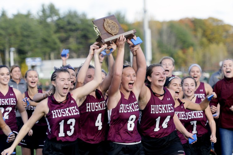  The MCI field hockey team celebrates after winning the Class B state championship last season over York at Falmouth High School.