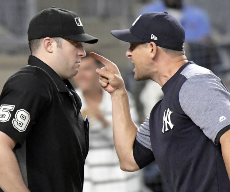 Yankees Manager Aaron Boone gets ejected in Friday night's game arguing balls and strikes with umpire Nic Lentz in the fifth inning. During his argument, Boone crouched down impersonating a catcher behind the plate.