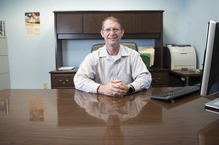 China Town Manager Dennis Heath sits at his desk Thursday at the China Town Office.