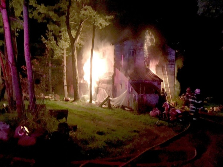 Flames engulf a home at 732 Industry Road in Farmington on Aug. 6. Angie Clark, 38, of Wilton, was arrested Friday on charges of arson and aggravated criminal mischief.