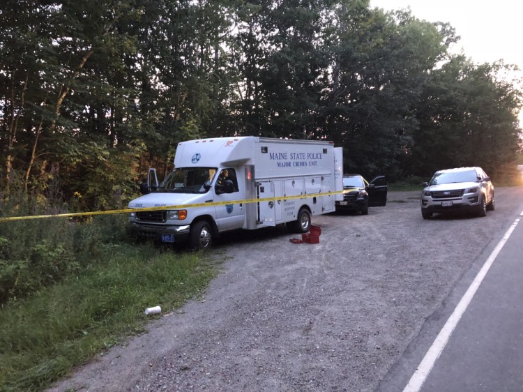 A state police major crimes van stands parked Thursday at the side of Weeks Mills Road in Augusta, near where a body was found Thursday afternoon.