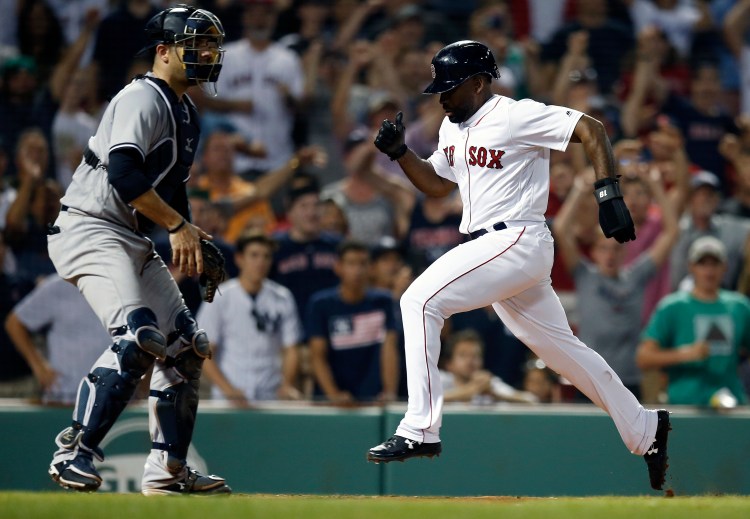 Boston's Jackie Bradley Jr., right, scores in front of New York's Austin Romine after a throwing error by Miguel Andujar to tie the game at 4-4 in the ninth inning Sunday at Fenway Park in Boston. The Red Sox won in the bottom of the 10th, 5-4.