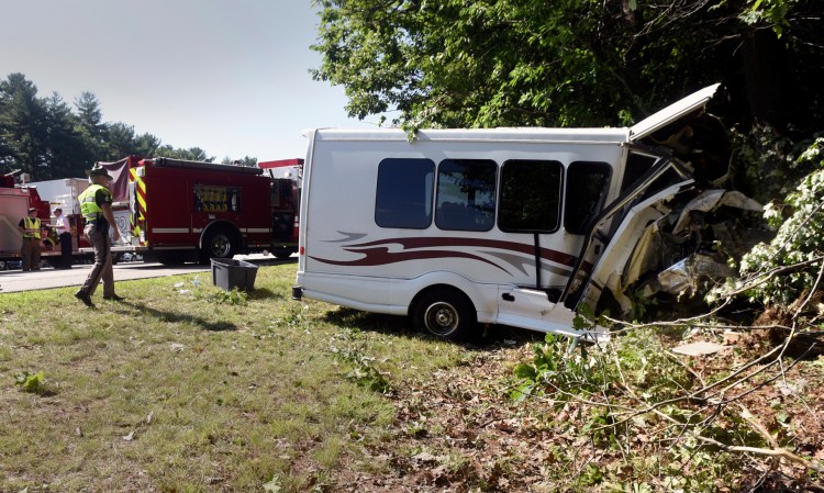 New Hampshire State Police investigate the crash on Interstate 95 in Greenland, N.H., on Aug. 10. The bus was carrying 11 children participating in a Kittery recreation program.