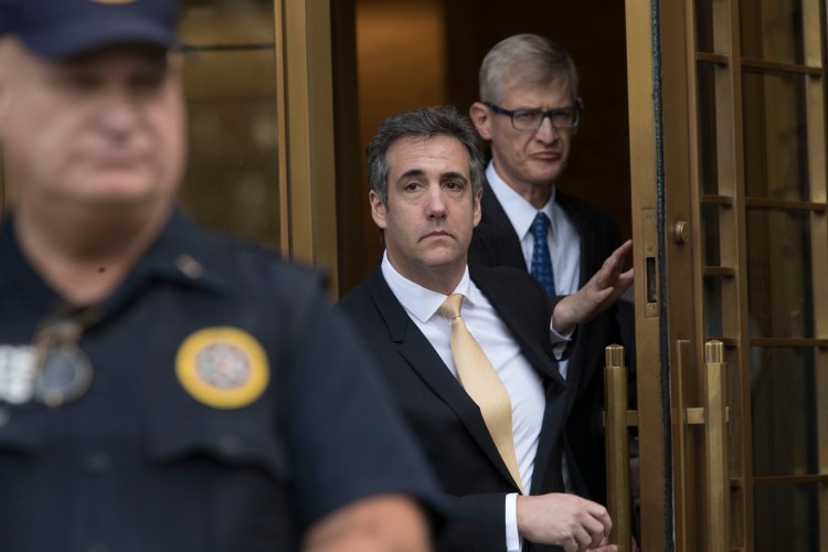 Michael Cohen, center, leaves Federal court, Tuesday, Aug. 21, 2018, in New York. Cohen, has pleaded guilty to charges including campaign finance fraud stemming from hush money payments to porn actress Stormy Daniels and ex-Playboy model Karen McDougal. 