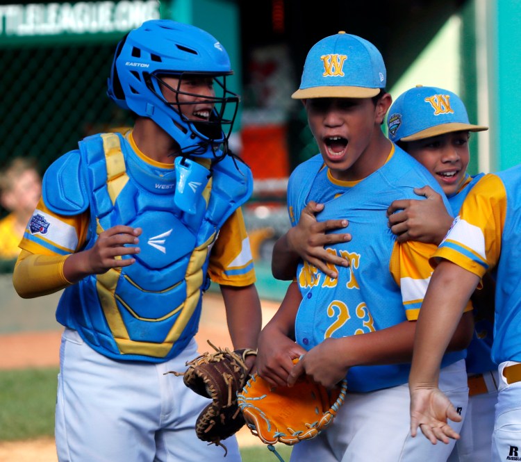 Honolulu, Hawaii's Aukai Kea (23) celebrates with catcher Bruce Boucher, left, and Taylin Oana after getting the final out of the United States Championship game against Peachtree City, Ga. on Saturday at the Little League World Series tournament in South Williamsport, Pa.