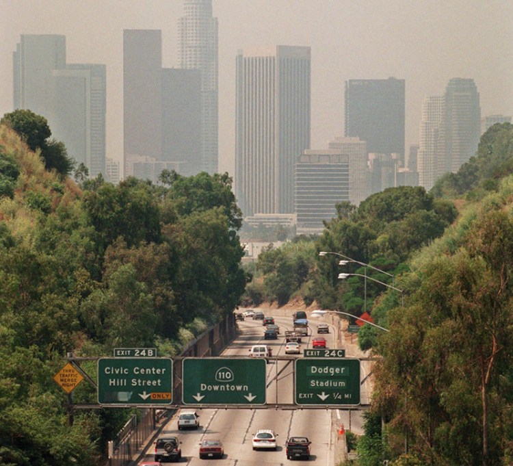 In this July 1998 file photo, traffic drives toward downtown Los Angeles on the 110 freeway as a curtain of smog shrouds the skyline. 
