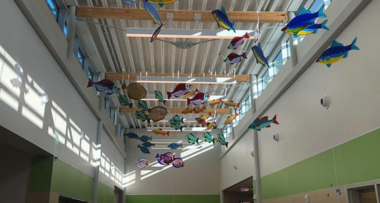Artist Janet Redfield created the glass fish installation that hangs in the entryway of the new school.
