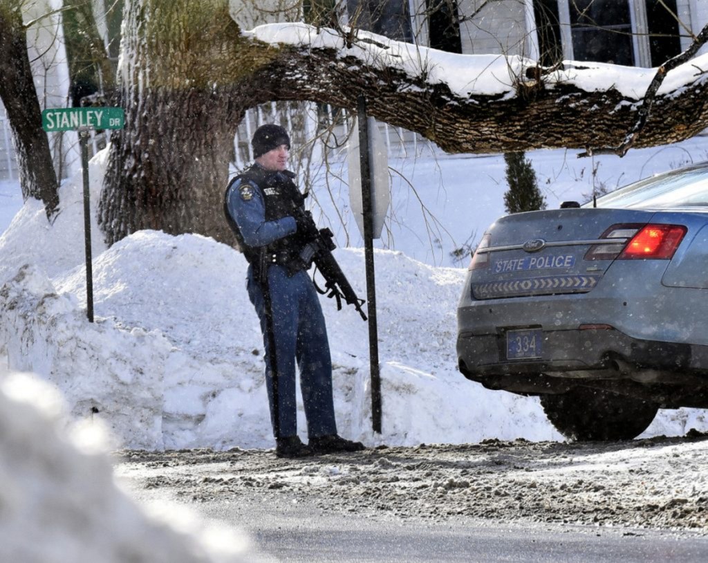 A Maine State Police trooper with an assault rifle stands guard in January at one end of Stanley Drive in Norridgewock as police search for a suspect in an armed robbery at the nearby Skowhegan Savings Bank branch.